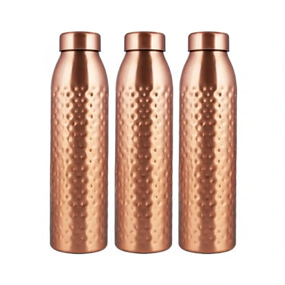Three copper-colored water bottles with a textured surface in front of their packaging box.